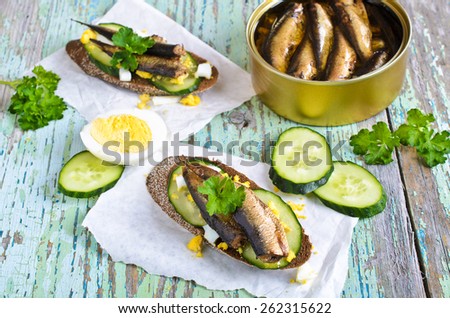 Sandwich with small smoked fish, cucumber and eggs