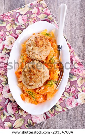 Meatballs with braised cabbage in a ceramic plate