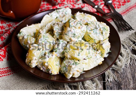 Potato salad with mustard seeds and white filling in rustic style