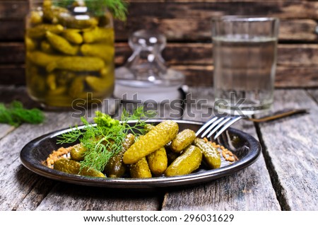Pickles is very small in the metal plate on a wooden surface