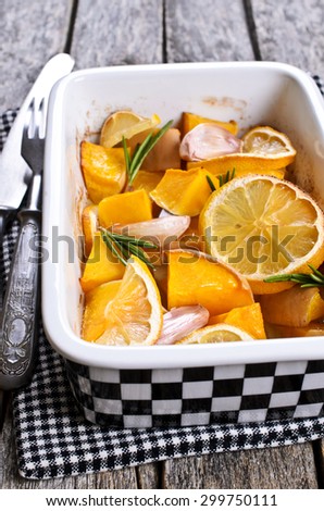 Pumpkin baked with garlic, lemon and rosemary in a ceramic form