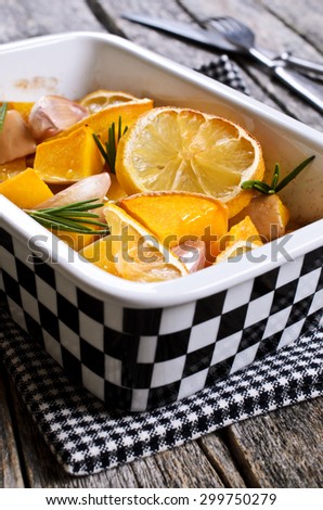 Pumpkin baked with garlic, lemon and rosemary in a ceramic form