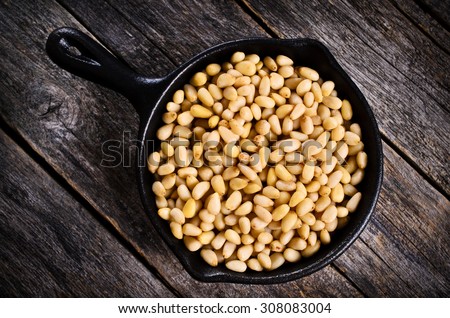 Pine nuts peeled on wood furniture in rustic style