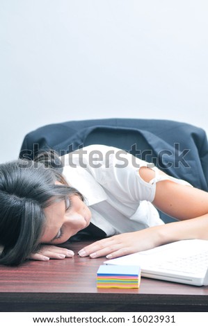 Sleeping girl at the office desk (portrait orientation)