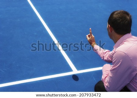 Chair umpire look at mark on court and says ball was OUT. Hard surface like on USA Tennis Tour, US Open, Cincinnati, Indian Wells, Montreal, Toronto, Atlanta and Dubai open. Copy space available.