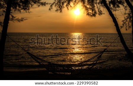 Photo of beautiful orange sunset on the sea, silhouette in sunrise peaceful landscape, sun down on town on coast, warm weather, romantic vacation, holiday concept.