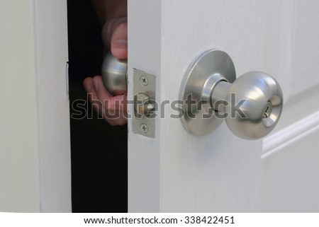 Hand are opened doorknob from the inside home