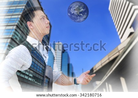 Double exposure of businessman with building and earth, Elements of this image furnished by NASA