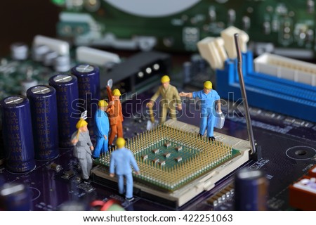 Selective focus of miniature engineer worker to fixed problem Control Processing Unit (CPU) processor,  mainboard computer and use for industry background.