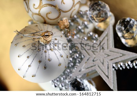 Two Christmas baubles, Cristal sphere and star golden background with reflections