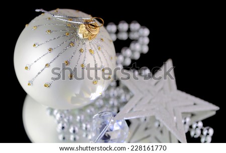 Christmas baubles, Cristal sphere and star on black background with reflections