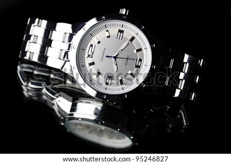 Wrist watch lying on dark background