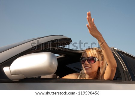 Driver girl is waving hand