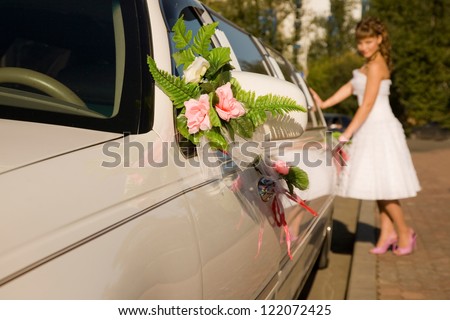 Bride is entering the limousine car.Selected focus