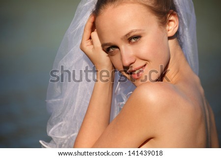Bride near water line.Close up portrait