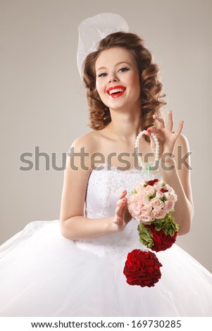 Pin-up bride with unusual bouquet.Professional make-up, hair and style