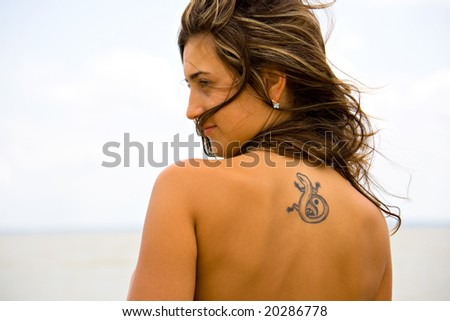 stock photo portrait of a young girl with tattoos on her back