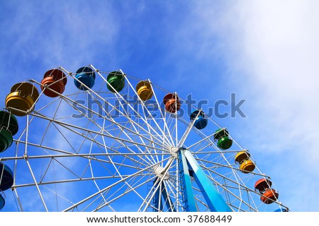 Roundabout - a big color wheel against the background of the blue cloudy sky
