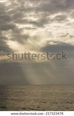 sun light shade through the dark blue cloud during sunrise time
