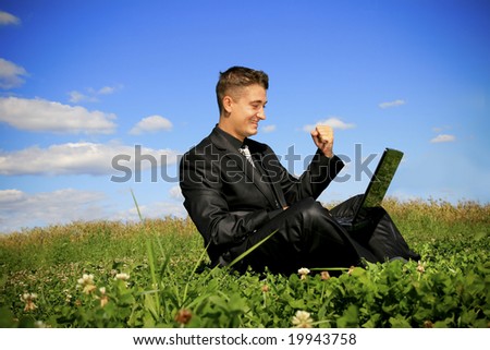 Young businessman outdoor with using laptop.