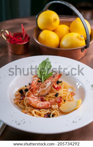 hot & chili spaghetti with prawn topping with caviar & lemon skin