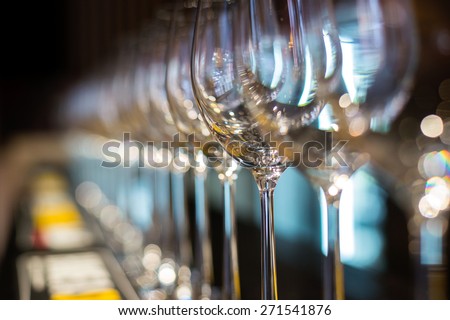 Wine glasses in row on bar