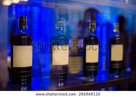 row of alcohol bottle on wooden shelf in fine dining restaurant
