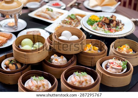 yumcha,The Arrangment of various dim sum in bamboo steamer with chinese bun , pao , bao zi , steamed dumpling , shumai on table in chinese restaurant