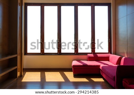 Red sofa near the panoramic window in living room