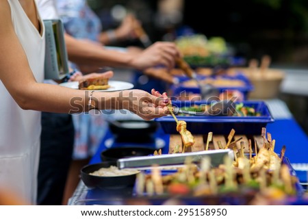 people group in the line catering buffet food indoor in luxury restaurant with meat colorful rice and vegetables