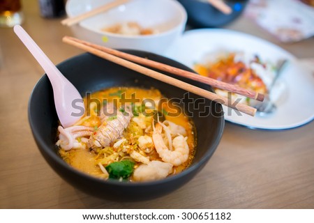 Thai Tom Yum spicy lime seafood noodle with mantis shrimp , squid , shrimp , crab , and fish fillet , the very famous thai favorite hot and sour noodle soup