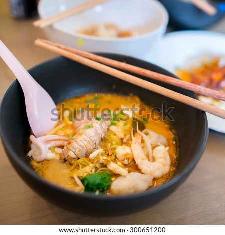 Thai Tom Yum spicy lime seafood noodle with mantis shrimp , squid , shrimp , crab , and fish fillet , the very famous thai favorite hot and sour noodle soup