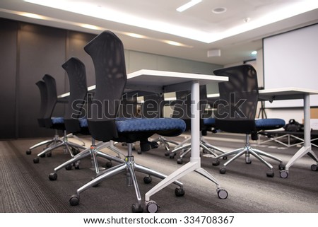 Side view of chairs and tables prepared for seminar