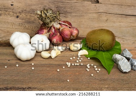 seasoning over wooden table background witch raw kiwi