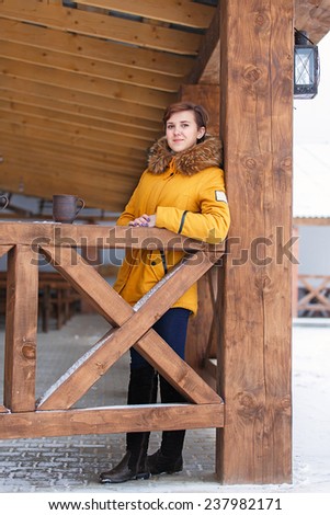 Young girl on the terrace in winter recreation center