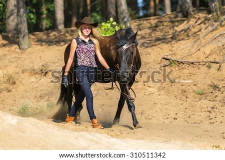 Beautiful young girl leading a horse.