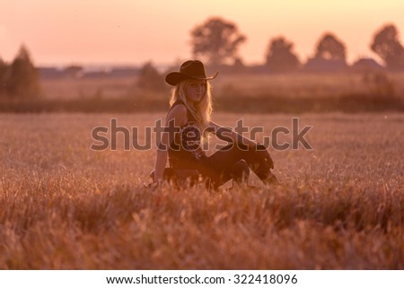 Cowgirl sitting in beautiful landscape.