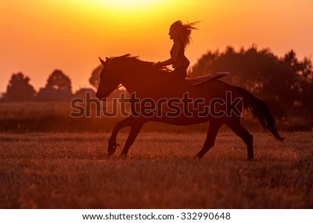 Silhouette of a woman riding a horse.