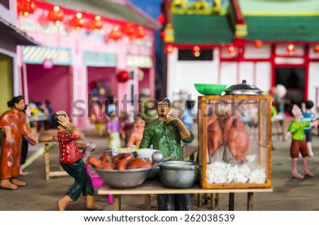 BANGKOK , THAILAND - MARCH 8, 2015 : Mini colorful clay dolls shown the way of life in the pass of Thai people.Street food. Display at the market named \