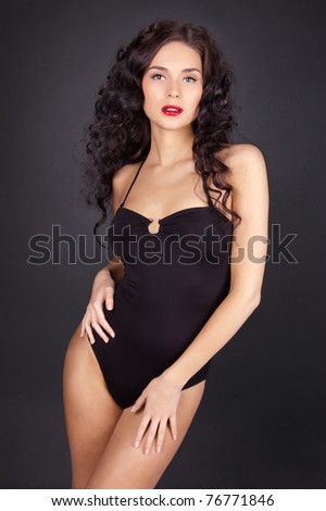 stock photo Beautiful young woman with perfect sexy body isolated on black