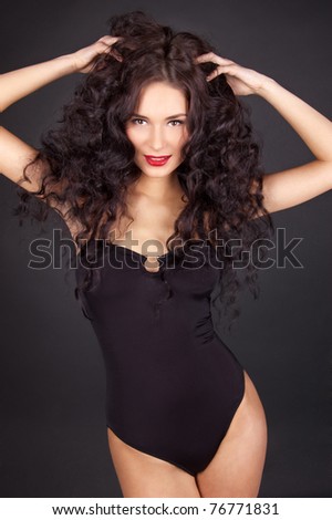 stock photo Beautiful young woman with perfect sexy body isolated on black