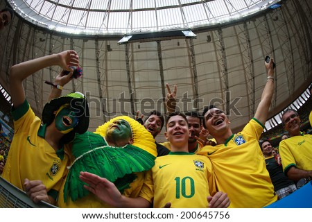BRASILIA, BRAZIL - June 23, 2014: Brazil fans celebrating at the 2014 World Cup Group A game between Brazil and Cameroon at Estadio Nacional Mane Garrincha. No Use in Brazil.