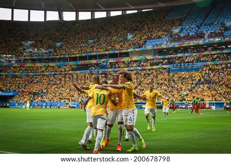 BRASILIA, BRAZIL - June 23, 2014: Brazil team celebrate after Fred\'s goal during the 2014 World Cup Group A game between Brazil and Cameroon at Estadio Nacional Mane Garrincha. No Use in Brazil.