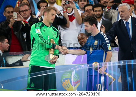 RIO DE JANEIRO, BRAZIL - July 13, 2014: Neuer of Germany wins the Golden Gloves Award for the Best Goalkeeper of the Tournament, while Messi wins the Golden Ball for the Best Player. NO USE IN BRAZIL.