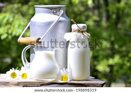 Milk in different container on the natural background.
