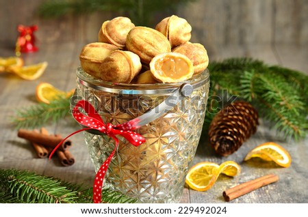 Cookies ''Nuts'' with sweeted condensed milk on festive background.