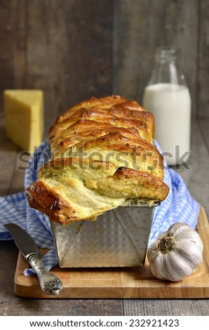 Cheese garlic pull-apart bread on a rustic background.