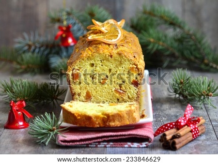 Christmas orange cake with dried apricot on winter background.