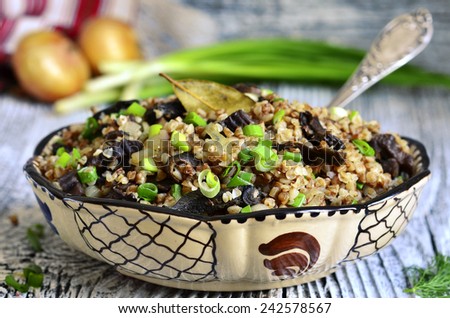 Buckwheat with dried mushrooms and fried onion - traditional dish of russian cuisine.