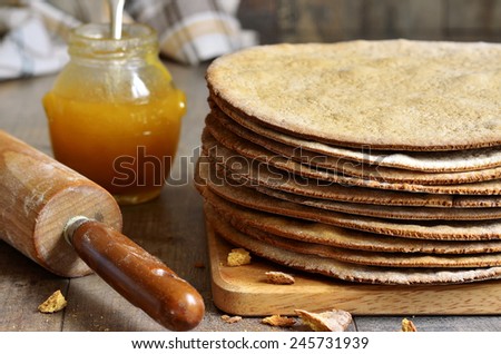 Baked layers for a honey cake on a wooden table.